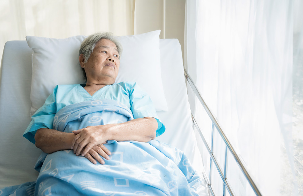 Woman in Hospital Looking out Window Woman in Hospital Looking out Window
